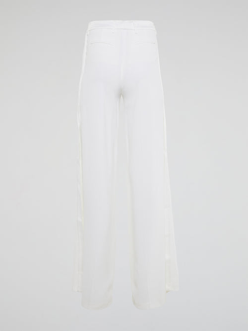 Elevate your style with these stunning white palazzo pants from Roberto Cavalli, designed to make you stand out from the crowd. The luxurious fabric drapes elegantly as you move, creating a sophisticated silhouette that is both comfortable and chic. Perfect for a day at the beach or a night on the town, these palazzo pants are a must-have addition to your wardrobe.