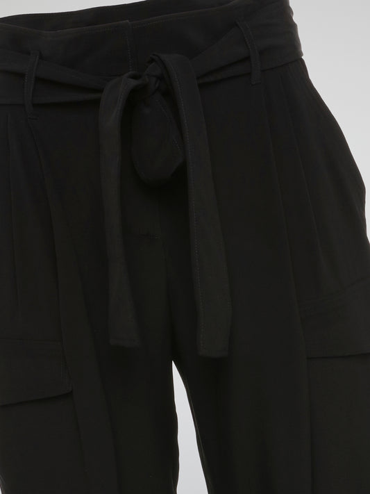 Feel fierce and fabulous in these Black Cargo Capris by Roberto Cavalli - a must-have staple for your wardrobe. The edgy cargo pockets add a unique touch to these versatile capris, perfect for any occasion. Make a statement and turn heads wherever you go with these chic and stylish capris.