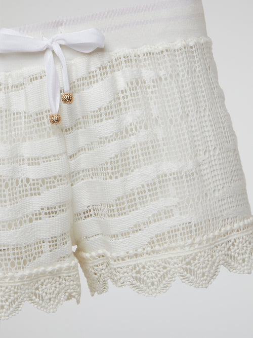 Elevate your summer wardrobe with these stunning white knitted shorts by Roberto Cavalli, perfect for lounging by the pool or a chic brunch with friends. Crafted with impeccable attention to detail, these shorts effortlessly blend comfort and style for a truly luxurious feel. Embrace your inner fashionista and make a statement with these must-have shorts that are sure to turn heads wherever you go.