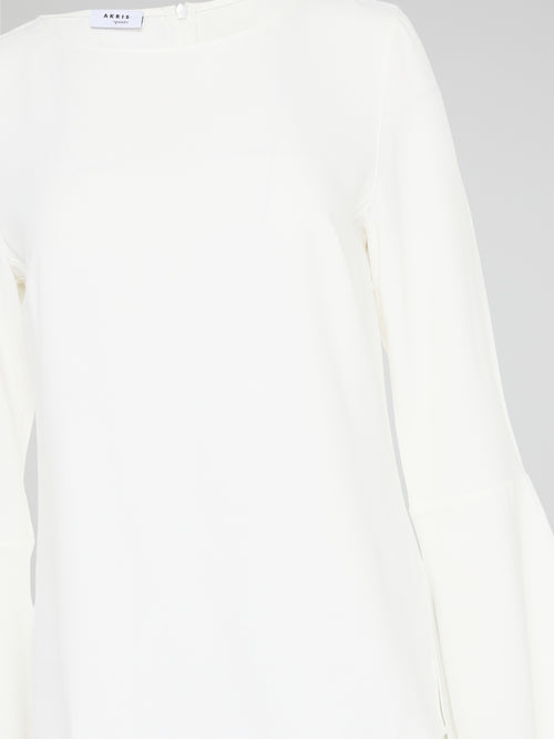 Elevate your everyday look with the White Flared Sleeve Top by Akris Punto. This contemporary and chic piece features unique flared sleeves that add a playful twist to your outfit. Made with high-quality materials, this top guarantees comfort and style, making it a must-have addition to your wardrobe.